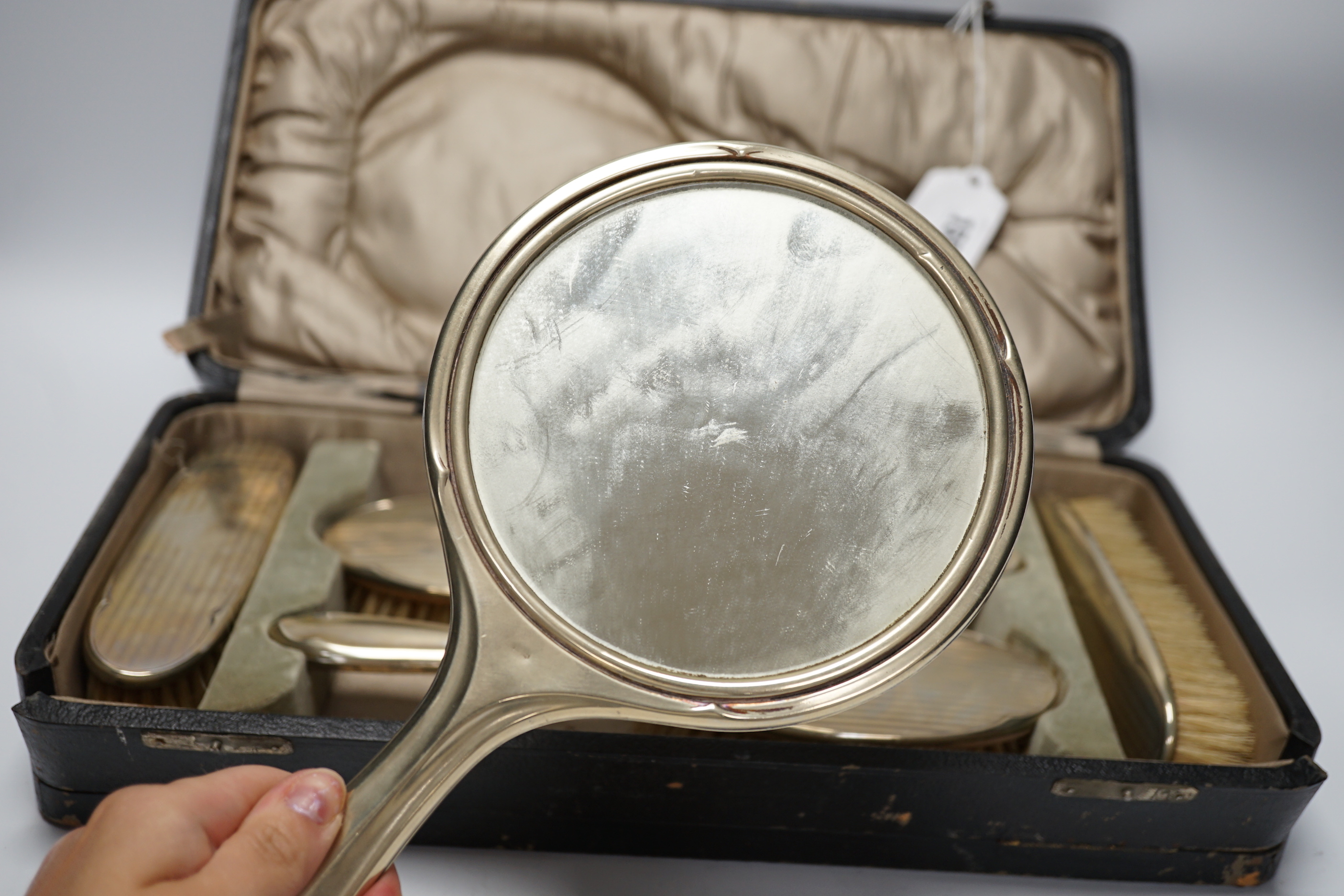 A cased 1930's six piece plated mirror and brush set.